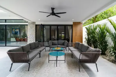 a living room with couches and a table at Diamond 1 Villa by G Estate Phuket in Ban Saiyuan (1)