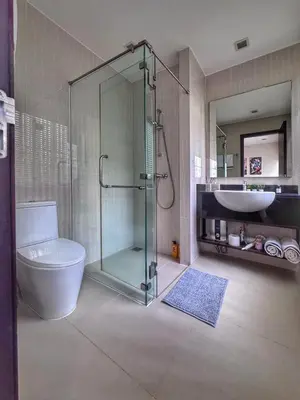 a bathroom with a shower and a toilet and a sink at Laguna Park 3BR Townhouse BangTao in Laguna Phuket