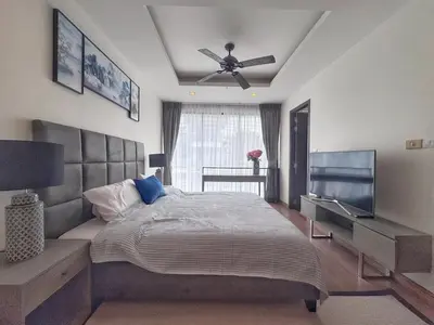 a bedroom with a bed and a ceiling fan at Laguna Park 3BR Townhouse BangTao in Laguna Phuket