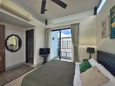 a bedroom with a large bed and a balcony at Laguna Park 3BR Townhouse BangTao in Laguna Phuket