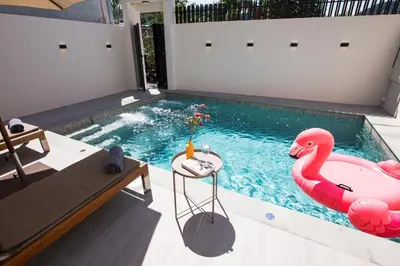 a swimming pool with a pink swan in it at Summer Villa Patong in Patong Beach