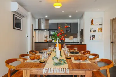 a wooden table in a kitchen with a dining room at Summer Villa Patong in Patong Beach