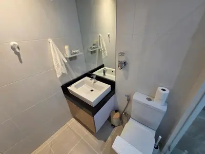 a white bathroom with a sink and a toilet at Beachside Gem with Lake, Cafes and more in Rawai Beach