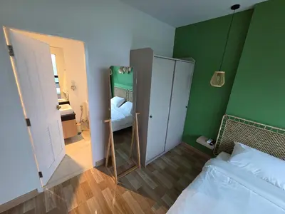 a small bedroom with a mirror and a bed at Beachside Gem with Lake, Cafes and more in Rawai Beach