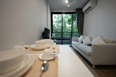 a living room with a couch and a table at ZcapeX2 94-18 by Silqstay in Thalang