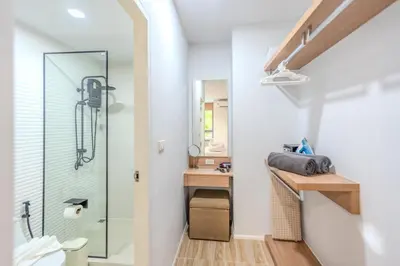 a bathroom with a glass shower and a desk at ZcapeX2 94-18 by Silqstay in Thalang