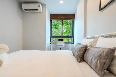a bedroom with a large white bed with a window at ZcapeX2 94-18 by Silqstay in Thalang