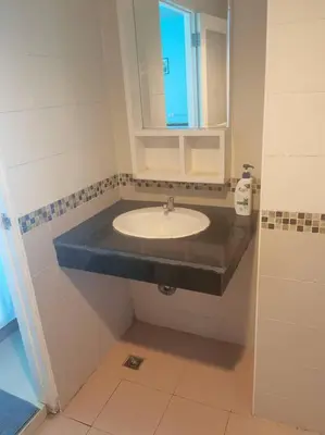 a bathroom with a sink and a mirror at \u5927\u53d4\u7684\u5c0f\u5c4b in Patong Beach