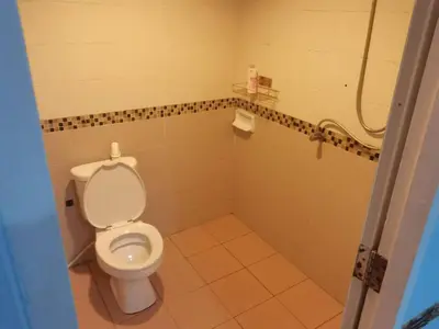 a bathroom with a toilet and a shower at \u5927\u53d4\u7684\u5c0f\u5c4b in Patong Beach