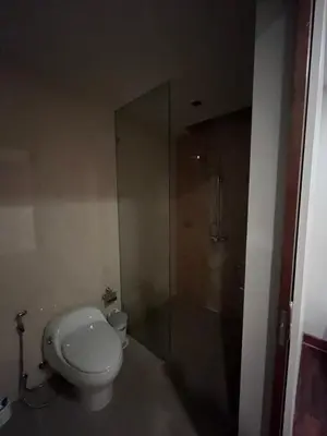 a bathroom with a toilet and a glass shower at Thebirdhouse Patong Phuket103 in Patong Beach