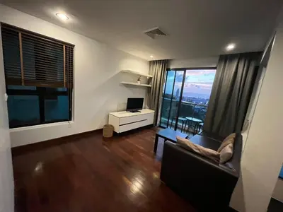 a living room with a couch and a desk and window at Thebirdhouse Patong Phuket103 in Patong Beach