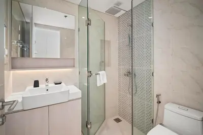 a bathroom with a sink and a glass shower at Cassia Residences in Laguna by Banyan Living in Laguna Phuket