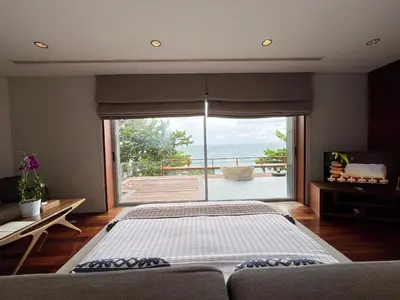 a bedroom with a large bed and a large window at Laemsingh Villa 1 - Luxury Villa 5 Bedrooms in Surin Beach