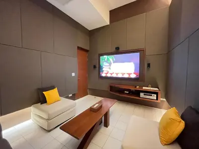 a living room with a couch and a tv at Laemsingh Villa 1 - Luxury Villa 5 Bedrooms in Surin Beach