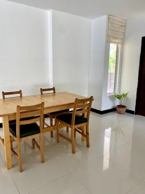 a dining room with a wooden table and chairs at Jungle Pool Villa in Chalong in Changwat Phuket