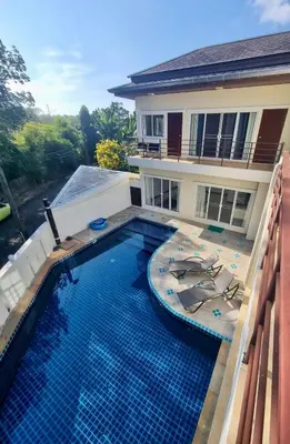 a swimming pool in front of a house at Jungle Pool Villa in Chalong in Changwat Phuket