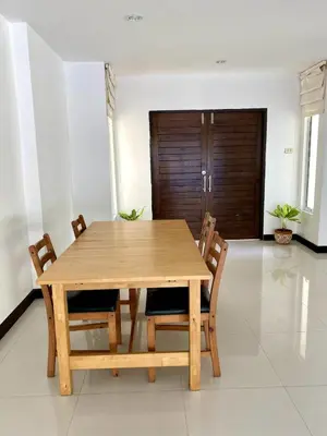 a wooden table and chairs in a room at Jungle Pool Villa in Chalong in Changwat Phuket