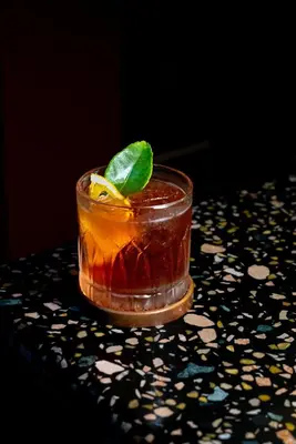 a drink sitting on a table with a drink at Ḥokma Boutique Hotel & Tropical Lounge in Phi Phi Don