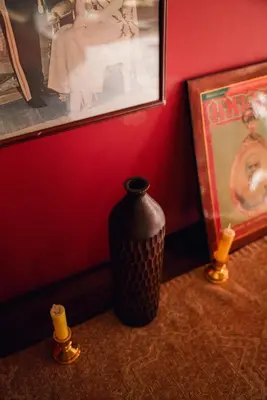 a black vase sitting on a table next to a wall at Ḥokma Boutique Hotel & Tropical Lounge in Phi Phi Don