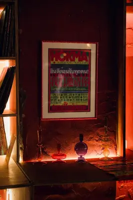 a picture of a poster on a wall with lights at Ḥokma Boutique Hotel & Tropical Lounge in Phi Phi Don