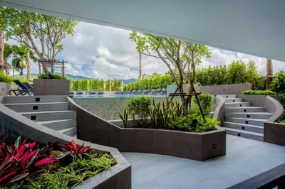 a view of a garden with benches and plants at Thai Me Up the Tower in Ban Klang