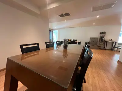 a dining room with a long table and chairs at Luxurious 5 Bedroom Condo, private pool, in Patong with Seaview in Patong Beach