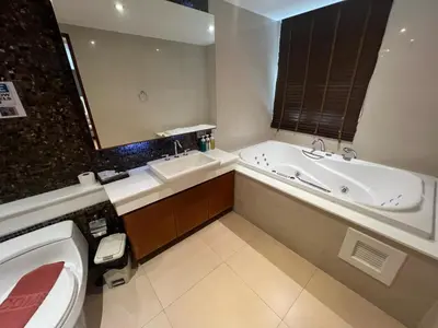 a bathroom with a tub and a sink and a toilet at Luxurious 5 Bedroom Condo, private pool, in Patong with Seaview in Patong Beach