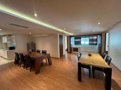 a dining room with a table and chairs and a kitchen at Luxurious 5 Bedroom Condo, private pool, in Patong with Seaview in Patong Beach