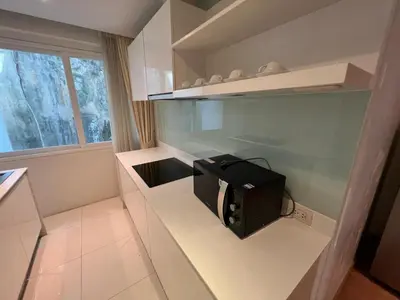 a small kitchen with a microwave on a counter at Luxurious 5 Bedroom Condo, private pool, in Patong with Seaview in Patong Beach