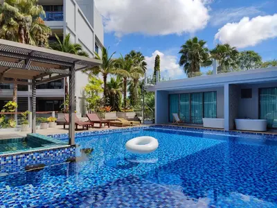 a swimming pool with a villa and a resort at The Regent Bangtao Spacious and comfortable studio at Bang Tao area in Bang Tao Beach