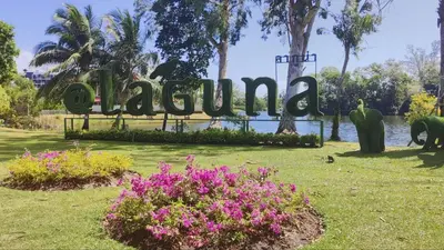 a sign for a park with flowers in the grass at The Regent Bangtao Spacious and comfortable studio at Bang Tao area in Bang Tao Beach
