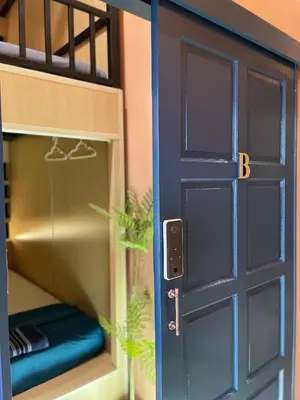 a blue door in a bunk bed room at Plearn Phuket Boutique Hostel in Ban Lo Long