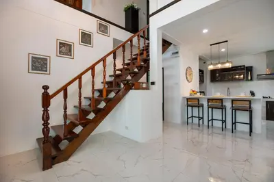 a staircase in a home with a kitchen and a counter at Villa Homey in Patong Beach