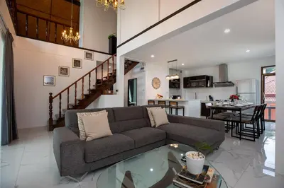 a living room with a couch and a table at Villa Homey in Patong Beach