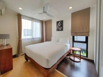 a bedroom with a large bed and a window at Modern 5-Bedroom Pool Villa in Laguna Phuket