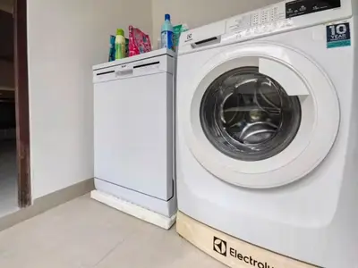 a white washing machine sitting in a room at Modern 5-Bedroom Pool Villa in Laguna Phuket