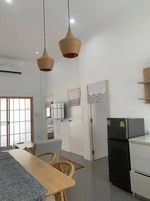 a kitchen with a table and a black refrigerator at \u65e5\u5f0f\u5c0f\u9547\u522b\u5885 in Phuket