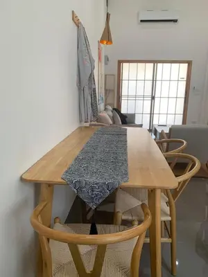 a wooden table with chairs and a table cloth on it at \u65e5\u5f0f\u5c0f\u9547\u522b\u5885 in Phuket