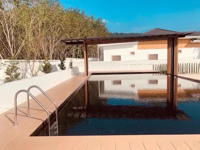 a swimming pool with a gazebo next to a house at \u65e5\u5f0f\u5c0f\u9547\u522b\u5885 in Phuket