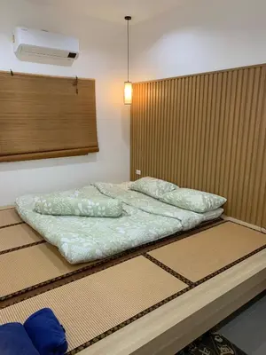 a bed in a room with avertisement at \u65e5\u5f0f\u5c0f\u9547\u522b\u5885 in Phuket
