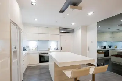 a kitchen with white cabinets and a white counter top at Balinese Apartment Kamala beach near Cafe del Mar in Kamala Beach