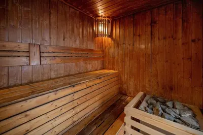 an empty wooden sauna with a bench in it at Balinese Apartment Kamala beach near Cafe del Mar in Kamala Beach