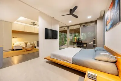 a bedroom with a bed and a living room at Balinese Apartment Kamala beach near Cafe del Mar in Kamala Beach