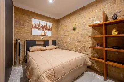 a bedroom with a bed and a brick wall at Balinese Apartment Kamala beach near Cafe del Mar in Kamala Beach