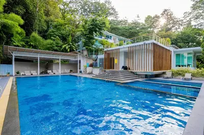 a house with a swimming pool in front of a house at Balinese Apartment Kamala beach near Cafe del Mar in Kamala Beach