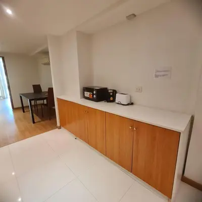 a kitchen with a counter with a microwave and a table at Luxury 2 Bedroom Duplex with Private Pool- Privilege Residence Patong in Patong Beach