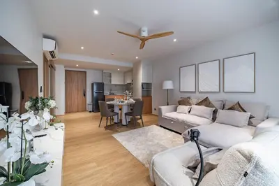 a living room with a couch and a table at Beachside Residences by NLA in Bang Tao Beach