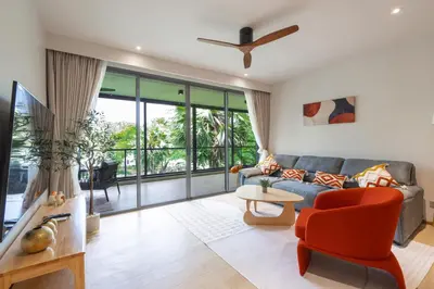 a living room with a couch and a table at Beachside Residences by NLA in Bang Tao Beach