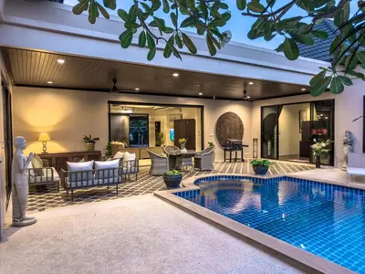 a villa with a swimming pool and a living room at Villa Intira 5 bedrooms with 12m private pool and garden in Rawai Beach