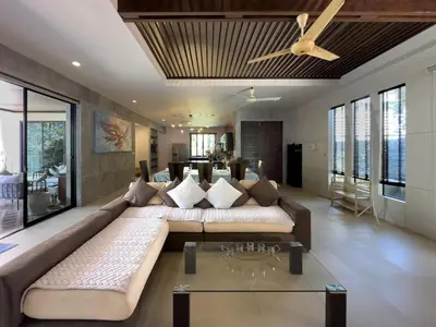 a living room with a large couch and a ceiling fan at Villa Intira 5 bedrooms with 12m private pool and garden in Rawai Beach